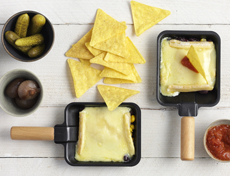 Tortilla chips trays with raclette cheese