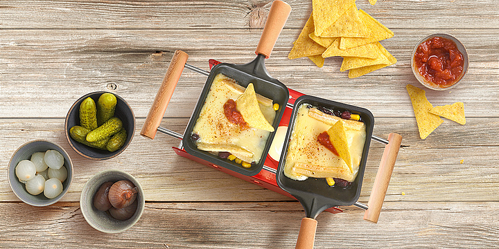 Tortilla chips trays with raclette cheese
