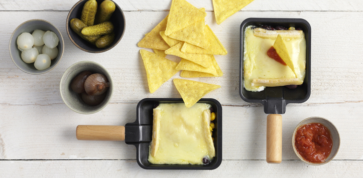 Tortilla chips trays with raclette cheese